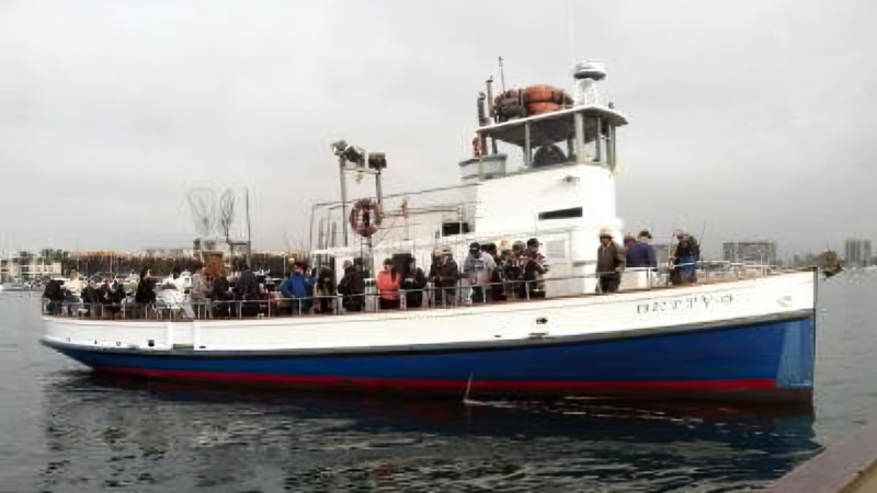 Fishing boat with lots of people on board